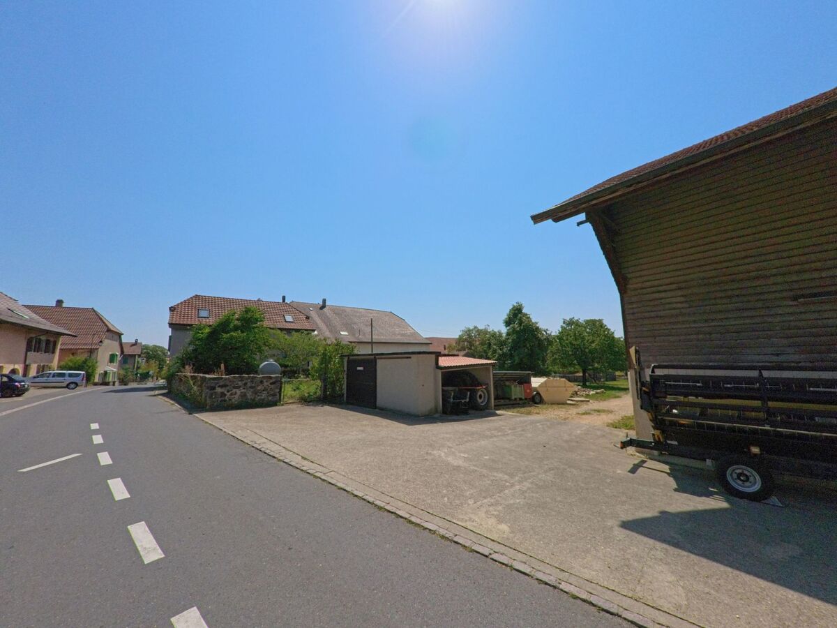 In Arnex-sur-Orbe (1321, Kanton Waadt) verlaeuft eine ruhige Strasse an einem Hof mit Nebengebaeuden vorbei, wo ein Kammerjaeger Einsaetze zur Kontrolle durchfuehren koennte.