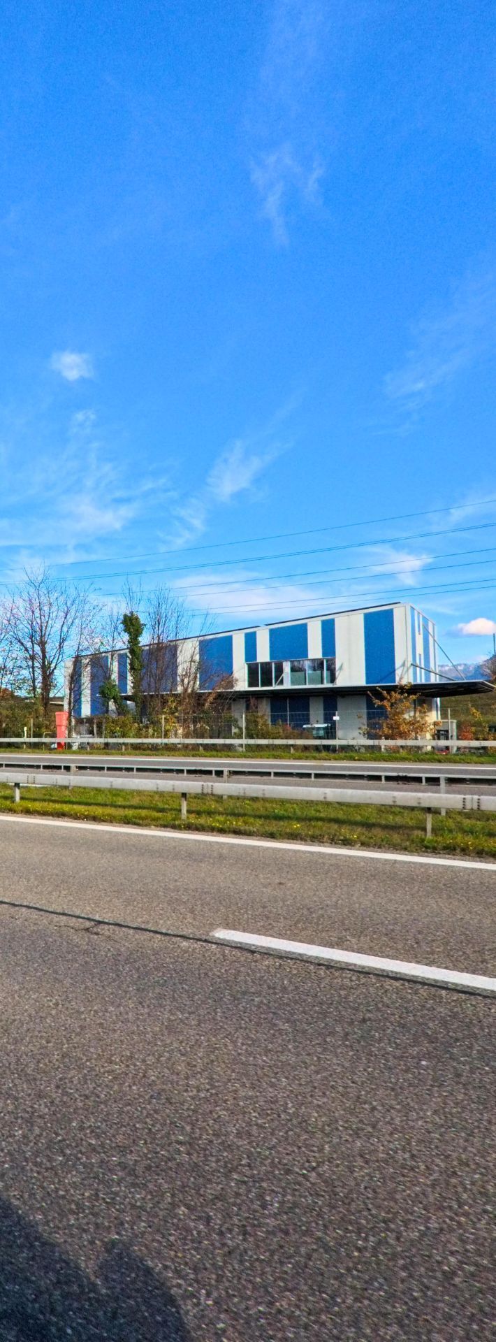 Am Rand von Diepoldsau (9444, Kanton St. Gallen) stehen mehrere helle Wohnhaeuser hinter einer offenen, frisch gerodeten Flaeche unter klarem Himmel.