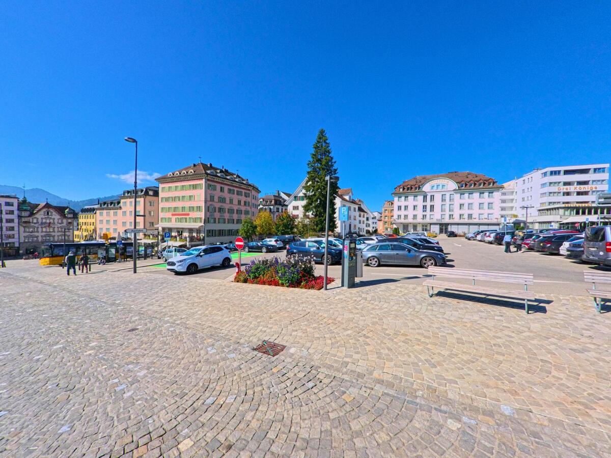 Eine offene Parkplatzfläche mit angrenzenden Gebäuden befindet sich im Ortskern von Einsiedeln (8840, Kanton Schwyz).