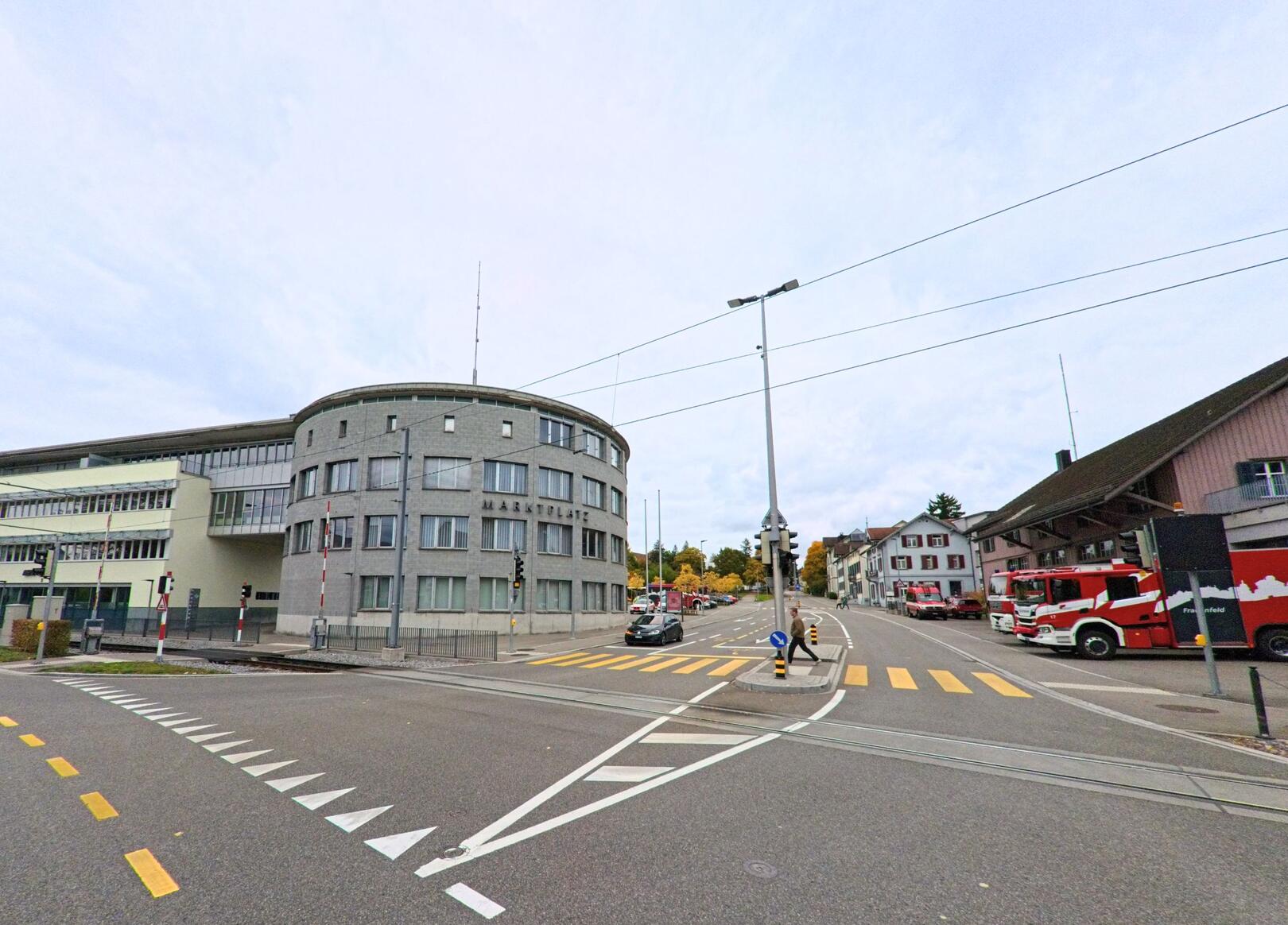 Eine grosse Kreuzung mit Fussgaengerstreifen und markantem Rundbau zeigt das Stadtbild in Frauenfeld (8500, Kanton Thurgau) unter bewölktem Himmel.