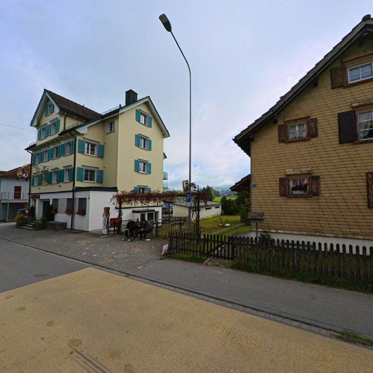 Mehrere Wohnhäuser mit traditionellen Formen prägen einen Strassenraum in Gonten (9108, Kanton Appenzell Innerrhoden).