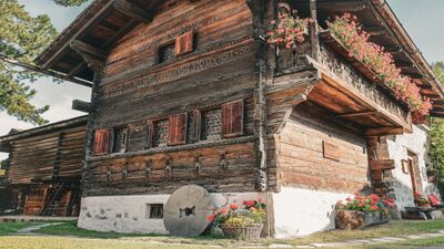 In Klosters (7250, Kanton Graubuenden) steht das historische Museum Nutli-Hueschi mit seiner typischen Holzbauweise, geschnitzten Balkonen und blumengeschmueckten Fenstern.