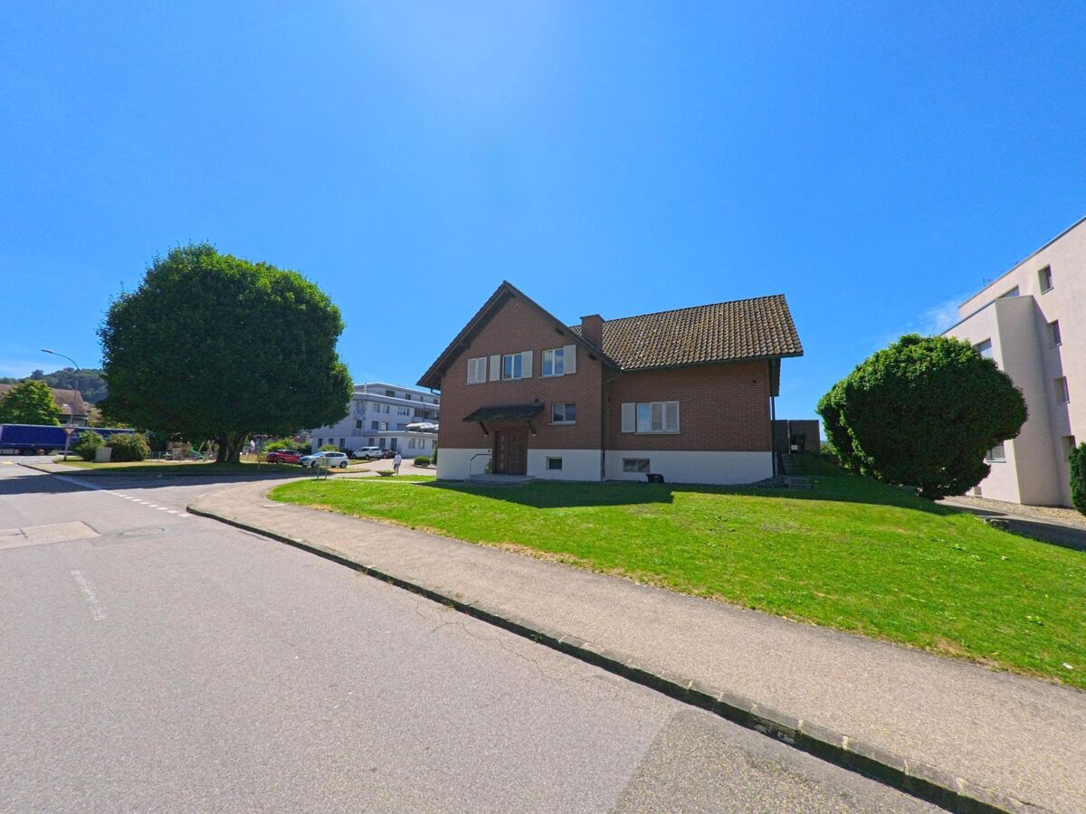 In Nebikon (PLZ 6244, Kanton Luzern) steht ein Wohnhaus mit Satteldach und vorgelagerter Gruenflaeche inmitten eines verkehrsberuhigten Wohngebiets.