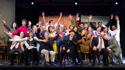 Die Mitglieder des Theater Einhorn Dübendorf in Dübendorf (8600, Kanton Zürich) posieren auf der Bühne für ein lebhaftes Gruppenfoto mit ausdrucksstarken Gesten.