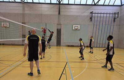 Hallenvolleyballtraining des VBC Neunkirch 8213 im Kanton Schaffhausen mit Spielern beim Block und Angriff am Netz in konzentrierter, sportlicher Trainingsatmosphäre.