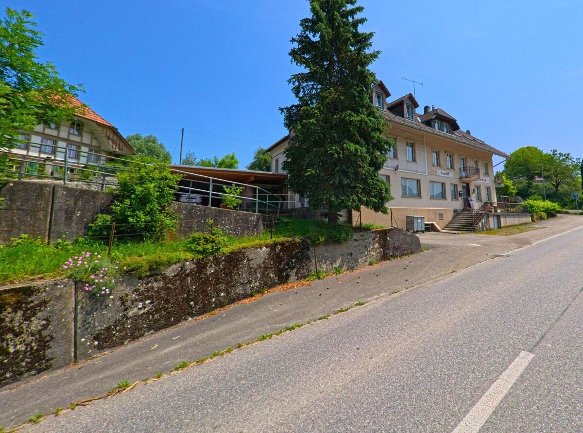 In Wyssachen (4954, Kanton Bern) steht ein mehrstöckiges Wohnhaus mit angeschlossener Gastwirtschaft an einer leicht ansteigenden Hauptstrasse.