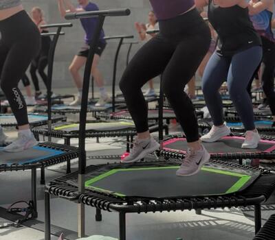Mehrere Personen trainieren in Zullwil (4234, Kanton Solothurn) gemeinsam auf Mini-Trampolinen in einem Fitnessraum waehrend eines Gruppenkurses.