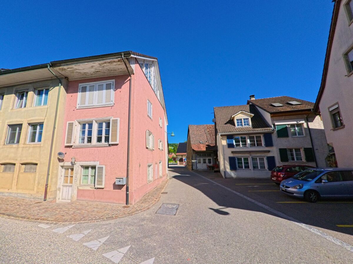 In Ziefen (4417, Kanton Basel-Landschaft) säumen farbenfrohe Fassaden eine enge Gasse, die sich durch den historischen Dorfkern zieht.